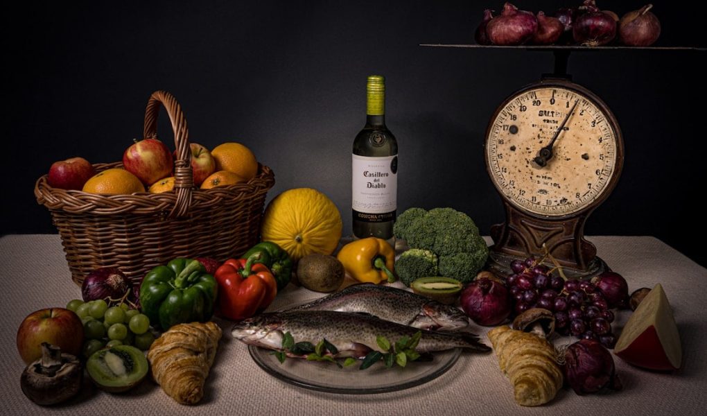 a table topped with a plate of food and a bottle of wine