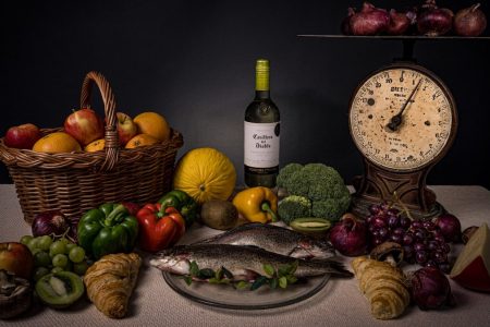 a table topped with a plate of food and a bottle of wine