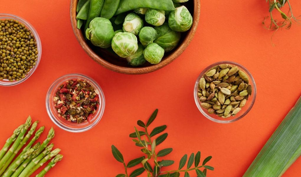 Vibrant display of nutritious vegetables and spices on a bold red background.
